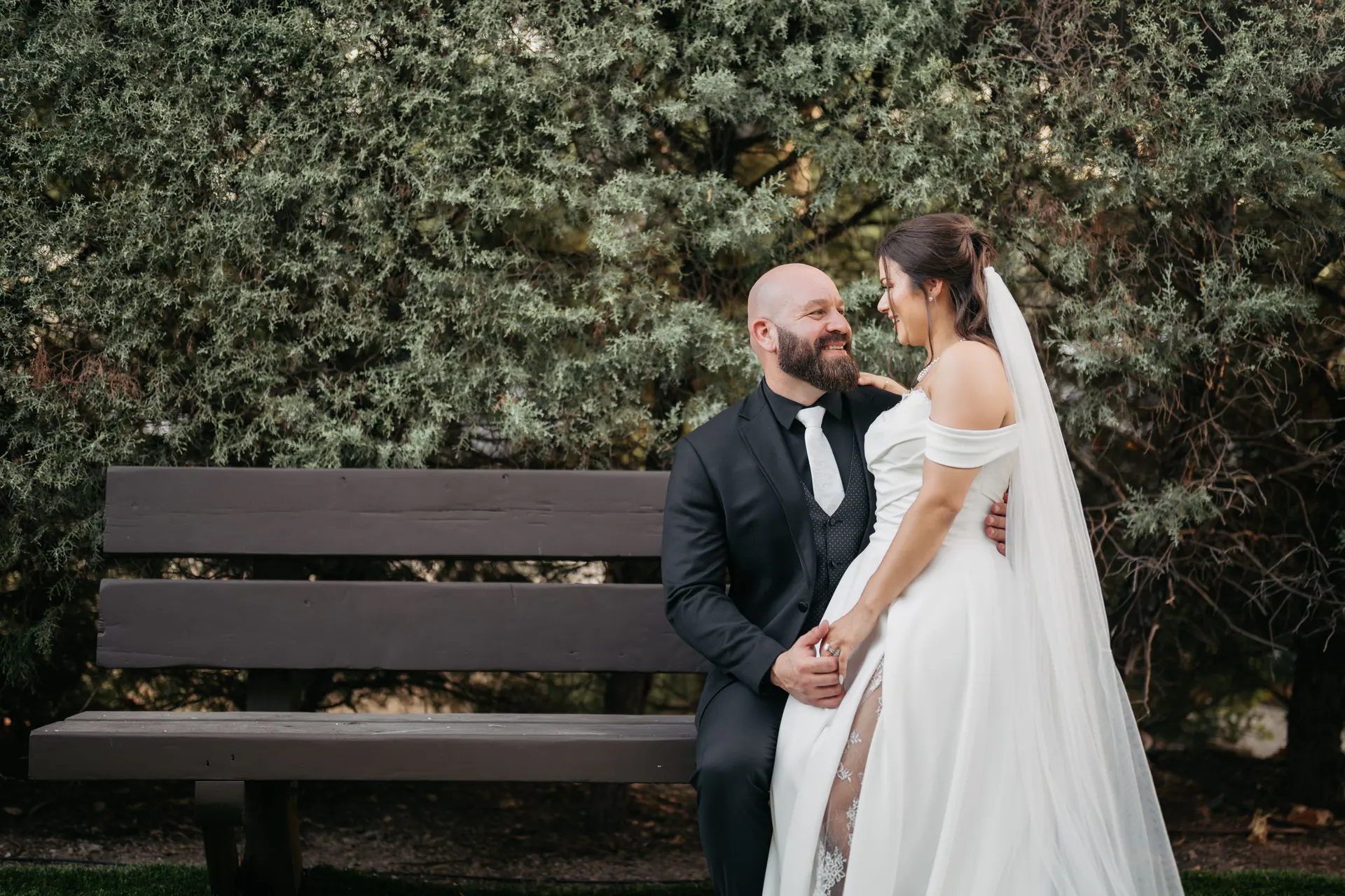 Travis and Hannah Ala seated together on a garden bench